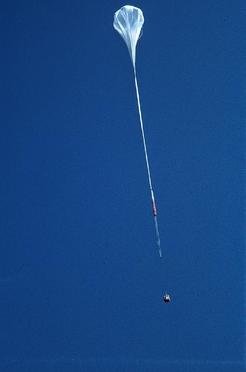 Balloon, parachute, and gondola shortly after launch. The ballon is filled only in part because at float altitude the gas (Helium) expands and fills the whole volume.