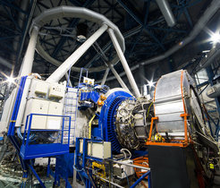 The KMOS instrument mounted on ESO’s Very Large Telescope at the Paranal Observatory in Chile. In this picture KMOS is the silver structure at the centre, surrounded by the blue ring structure that connects it to the VLT Unit Telescope 1, which appears on the left. On the right the large silver cylinder supports the extensive KMOS electronics and allows them to rotate as the telescope moves across the sky.