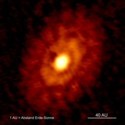 ALMA-Bild der jungen Staubringe, in denen Planeten entstehen, um den weniger als 500.000 Jahre alten Proto-Stern IRS 63.