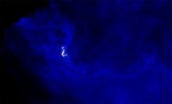 The B5 complex (red and green; radio images taken with the VLA and GBT) seen within its neighborhood, embedded in dust (blue) as seen with ESA’s Herschel Space Observatory, in infrared light.