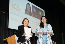 Award ceremony with a presentation screen in the background.